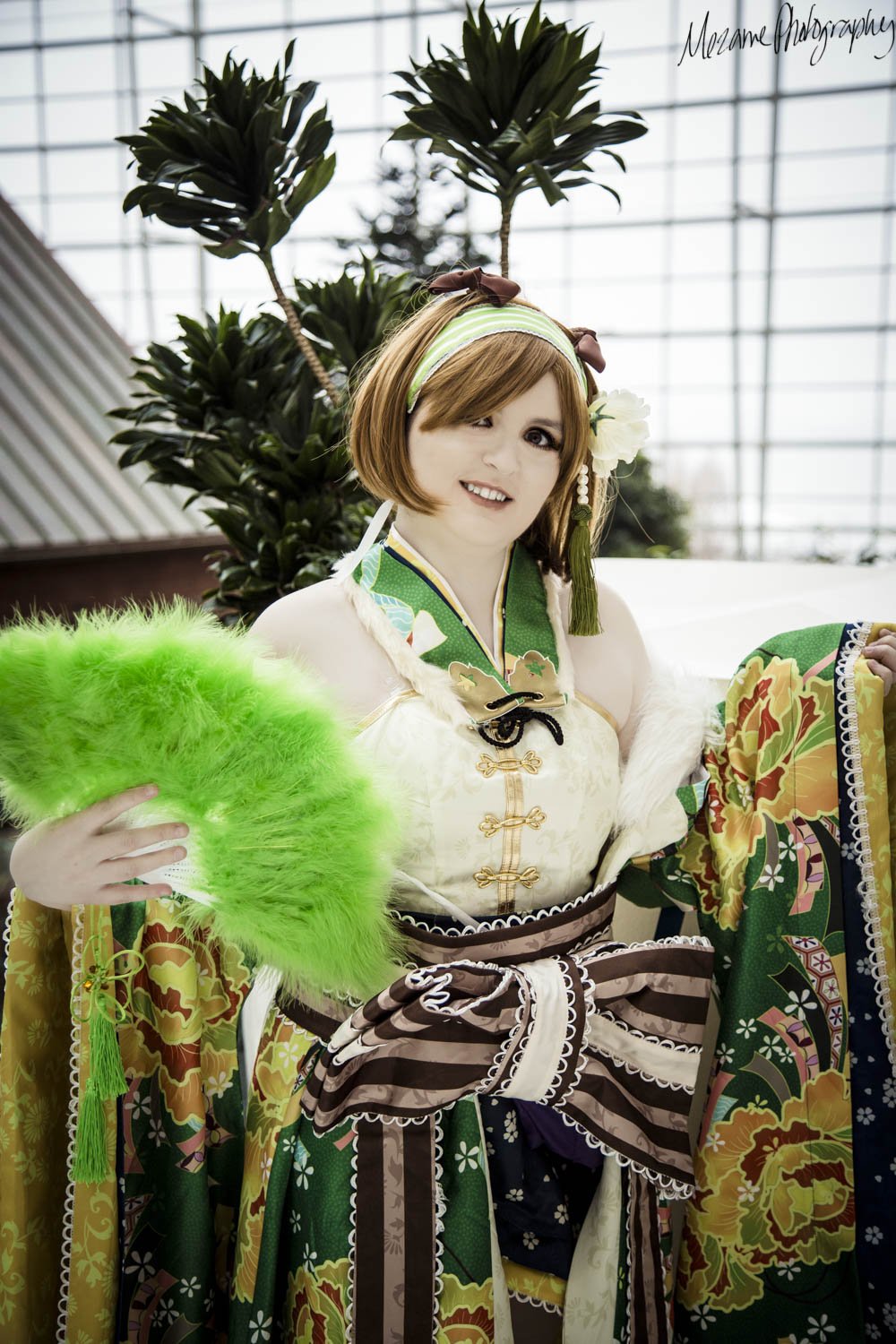 Full body shot of Hanayo cosplay, holding a green fan.