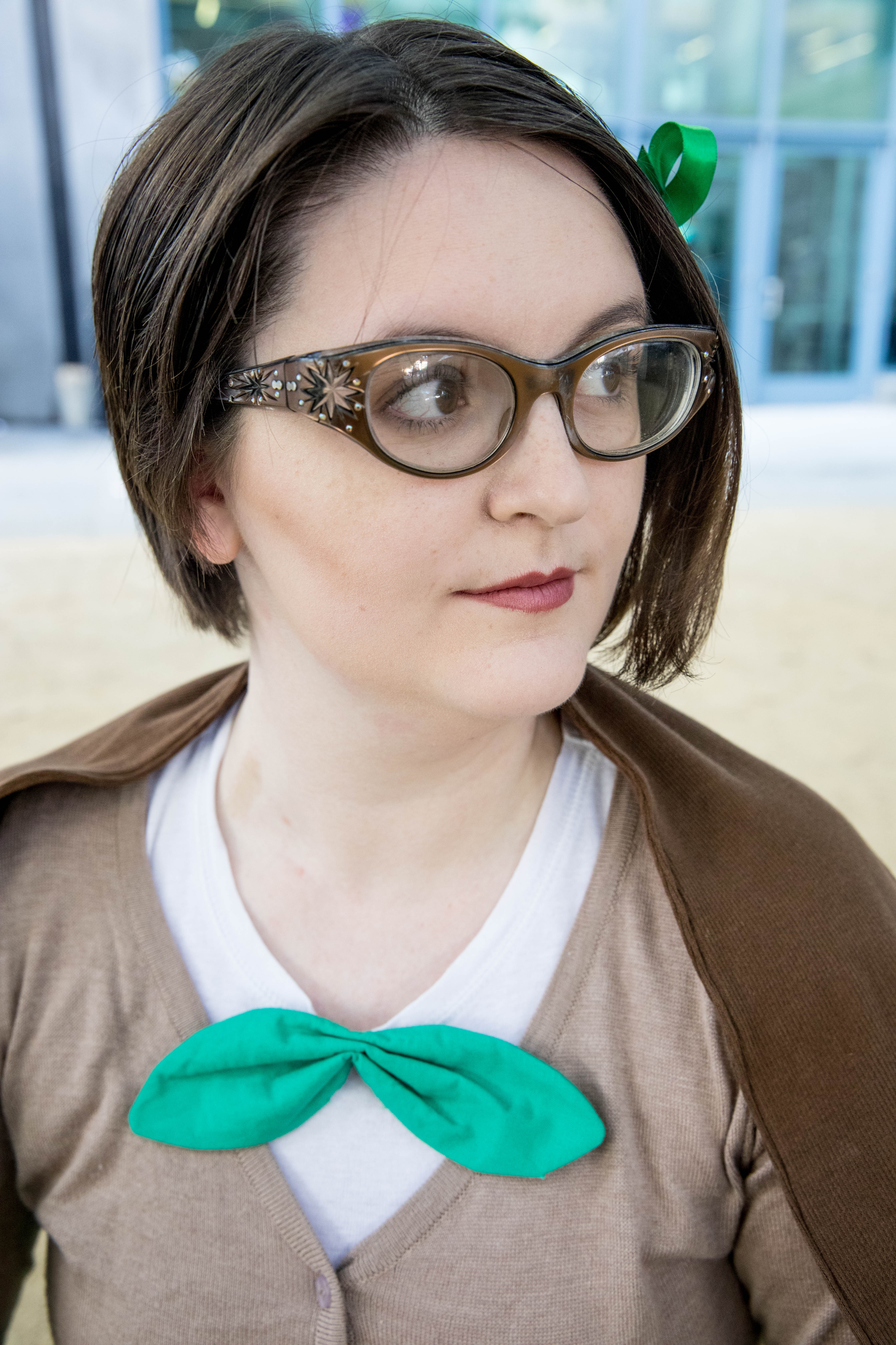 Portrait of face, wearing Rowlet cosplay.