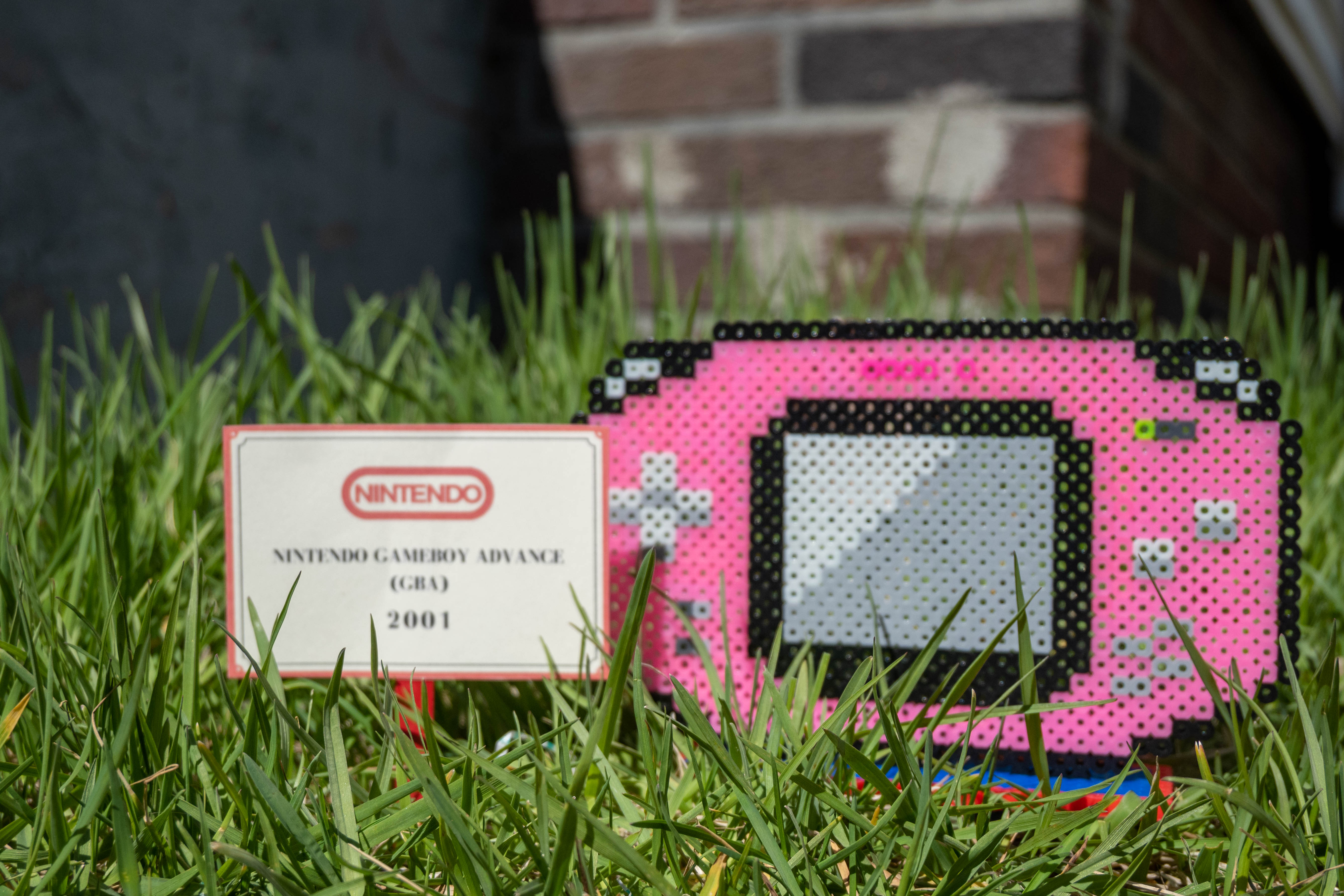 Pink Gameboy Advance made out of Perler brand fuse beads.