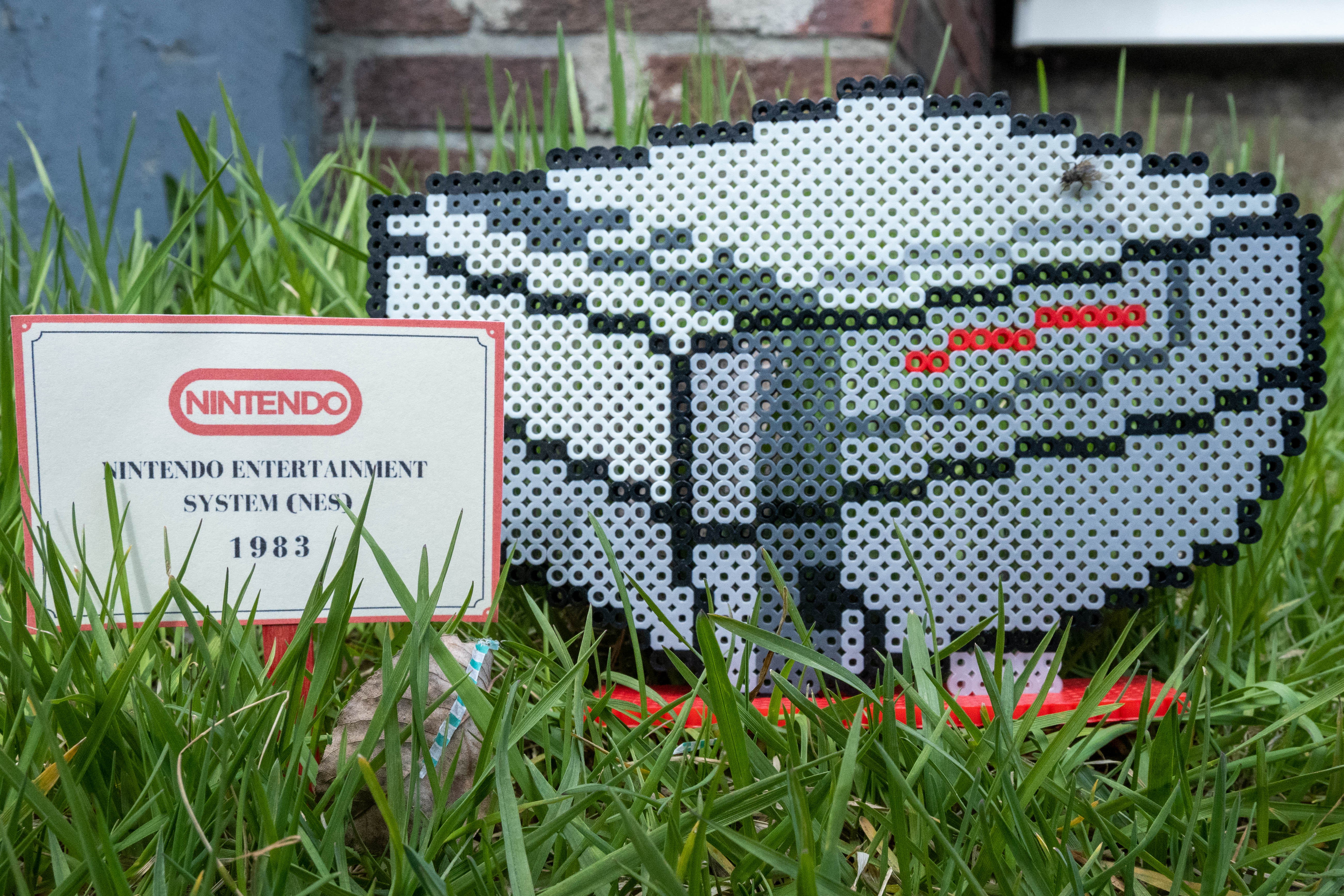 Grey Nintendo Entertainment System made out of Perler brand fuse beads.