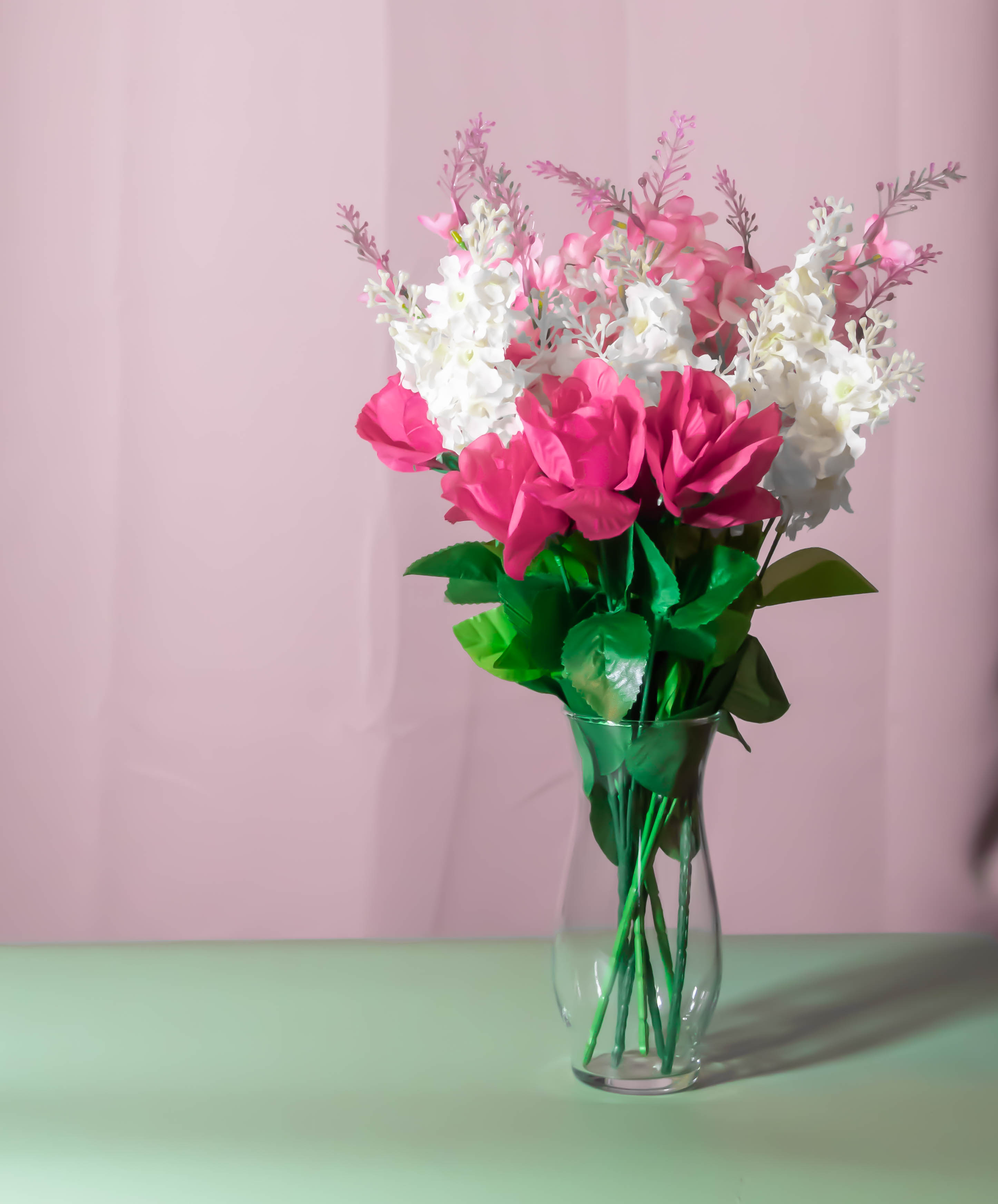 A vase of flowers against a solid background